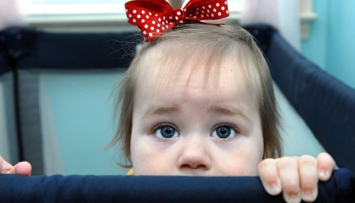 Little Girl in Pack n Play