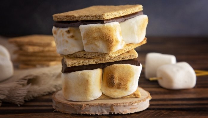 A double-decker smore on a wood table.