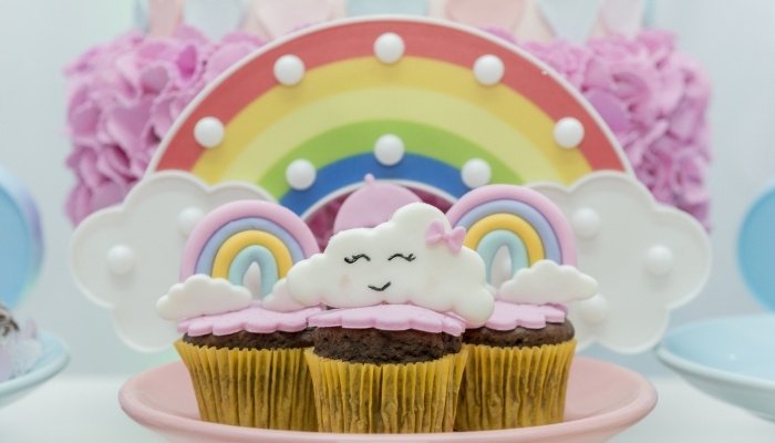 Cupcakes and decorations with a rainbows and clouds theme.