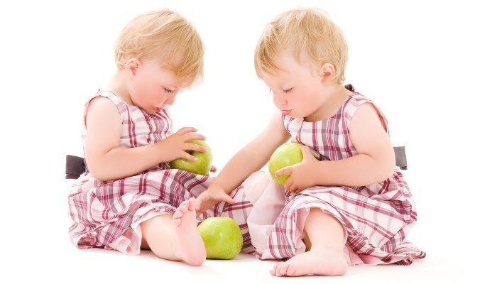 Twin Girls Playing With Apples