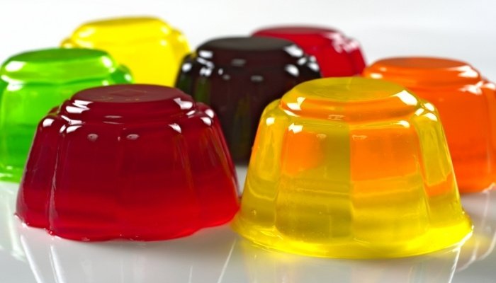 Yellow, red, orange, green, and purple jello just released from mold.