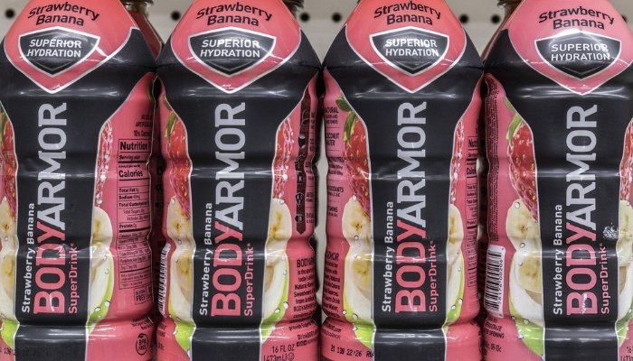 Store display of Bodyarmor strawberry banana drinks.