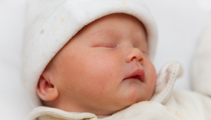 A close-up look at a newborn baby sleeping.