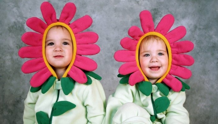 Twin sisters dressed as flowers for Halloween.