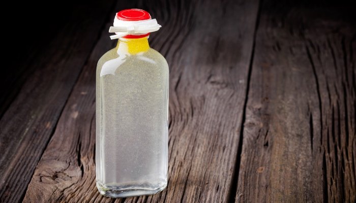 A bottle of baby oil on a wooden table.