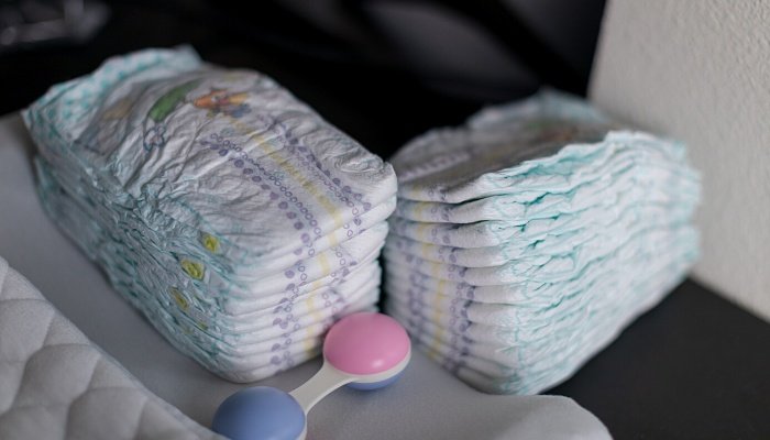 Two small stacks of diapers in a baby's nursery.