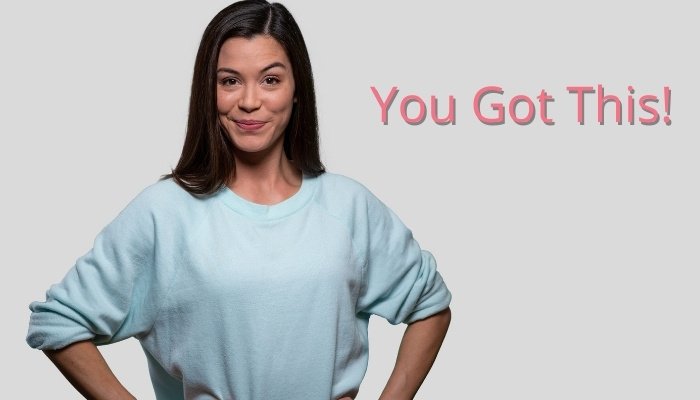 A confident woman with a smirk on her face and her hands on her hips with the text You Got This!