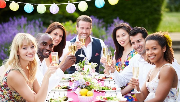 A group of friends enjoying a dinner party held outdoors.