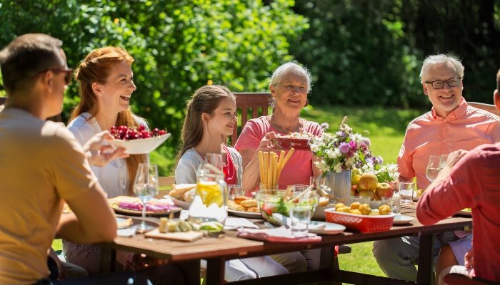 An informal family dinner held outside on a pretty day.