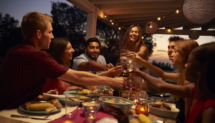 A group of friends enjoying a dinner party outside.