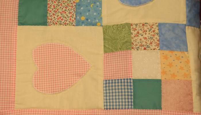 A cute baby quilt made by loving hands.