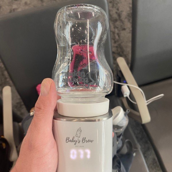 Warming Bottle in Babys Brew Warmer at Airport
