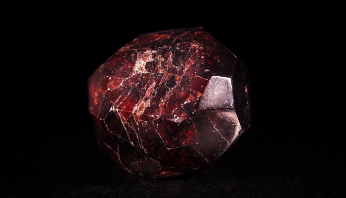A garnet crystal against a black background.