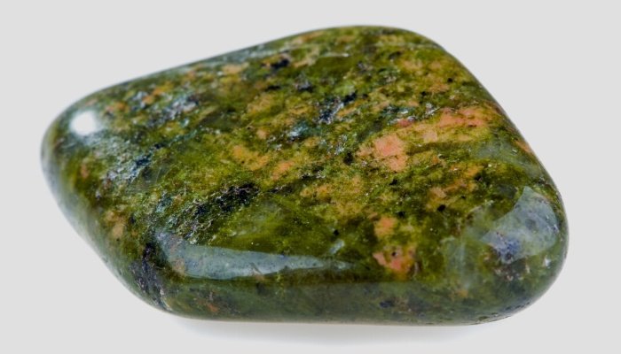 A unakite crystal against a white background.