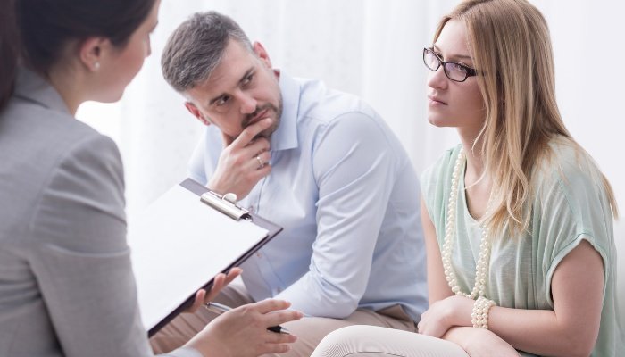 Woman looking resentful during a parent counseling session.