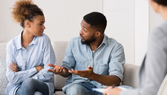 Parents arguing with one another during a counseling session.