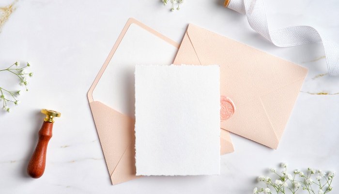 A woman's stationery set with a wax stamp for sealing.