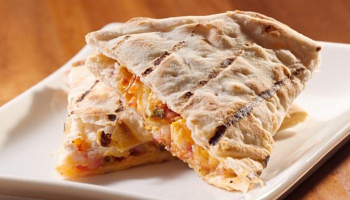 Cheese and chicken quesadillas on a white plate.