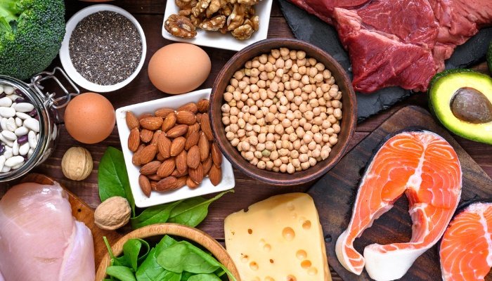 A variety of healthy foods high in protein arranged on a table.